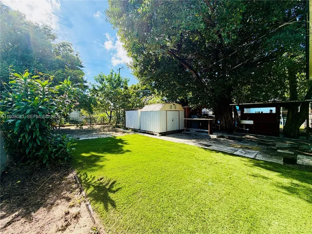 a swimming pool with outdoor seating and yard