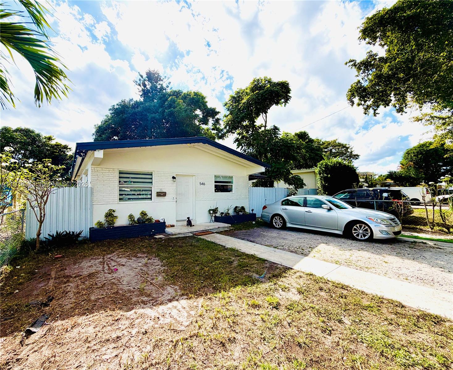 546 East 39th Street Hialeah, FL 33013 - Photo 2 of 24 a view of a house with backyard and trees