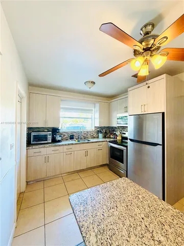 a kitchen with a refrigerator and countertop