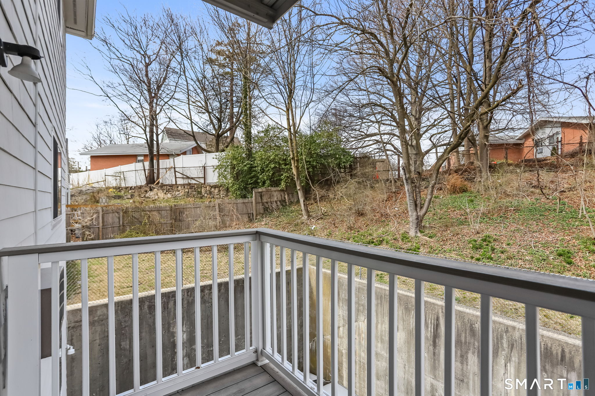 7 Hamilton Avenue, Unit 32 Norwalk, CT 06854 - Photo 12 of 14 a view of a wooden deck next to a yard