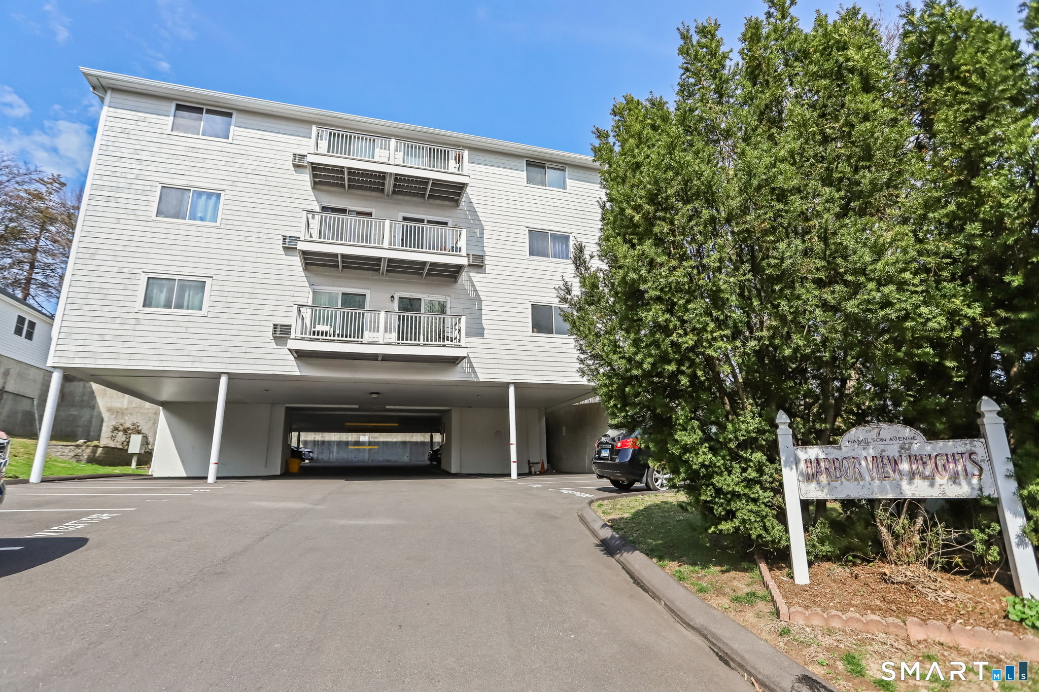 7 Hamilton Avenue, Unit 32 Norwalk, CT 06854 - Photo 14 of 14 a front view of a house with a yard