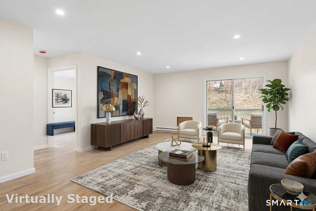 7 Hamilton Avenue, Unit 32 Norwalk, CT 06854 - Photo 2 of 14 a living room with furniture and a large window