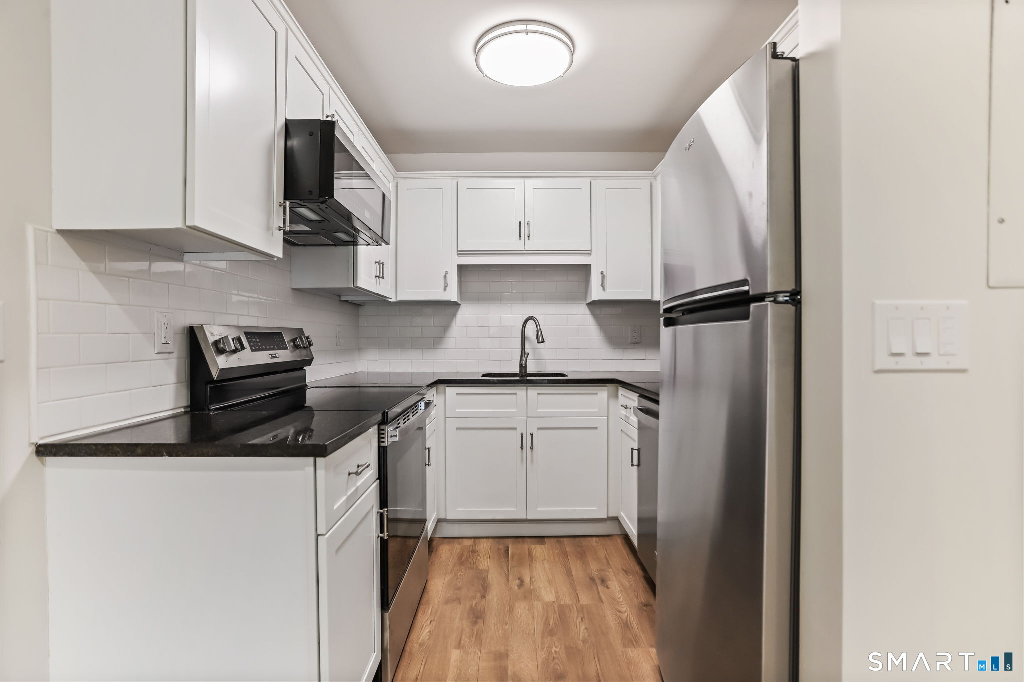 7 Hamilton Avenue, Unit 32 Norwalk, CT 06854 - Photo 5 of 14 a kitchen with a refrigerator sink and microwave