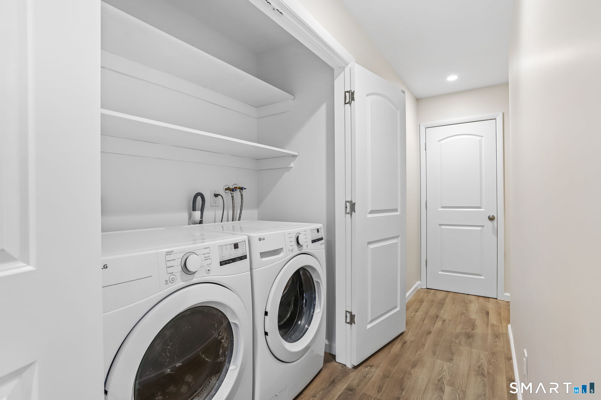 7 Hamilton Avenue, Unit 32 Norwalk, CT 06854 - Photo 6 of 14 a view of storage and utility room with washer and dryer