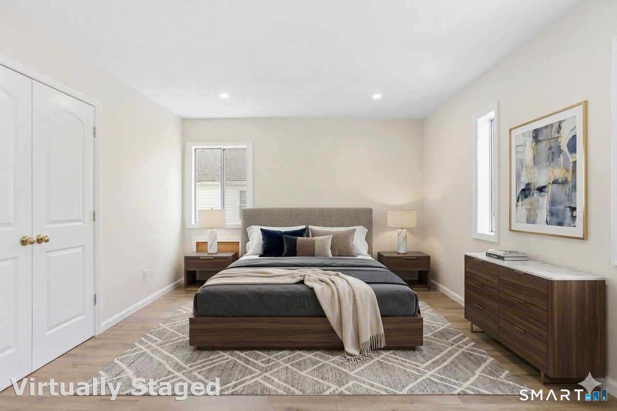 7 Hamilton Avenue, Unit 32 Norwalk, CT 06854 - Photo 8 of 14 a bedroom with a large bed and a window