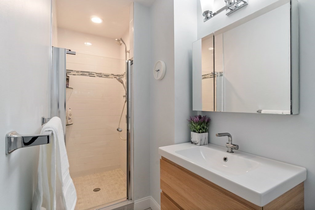51 Donna Road Newton, MA 02459 - Photo 15 of 30 a bathroom with a sink a mirror and shower