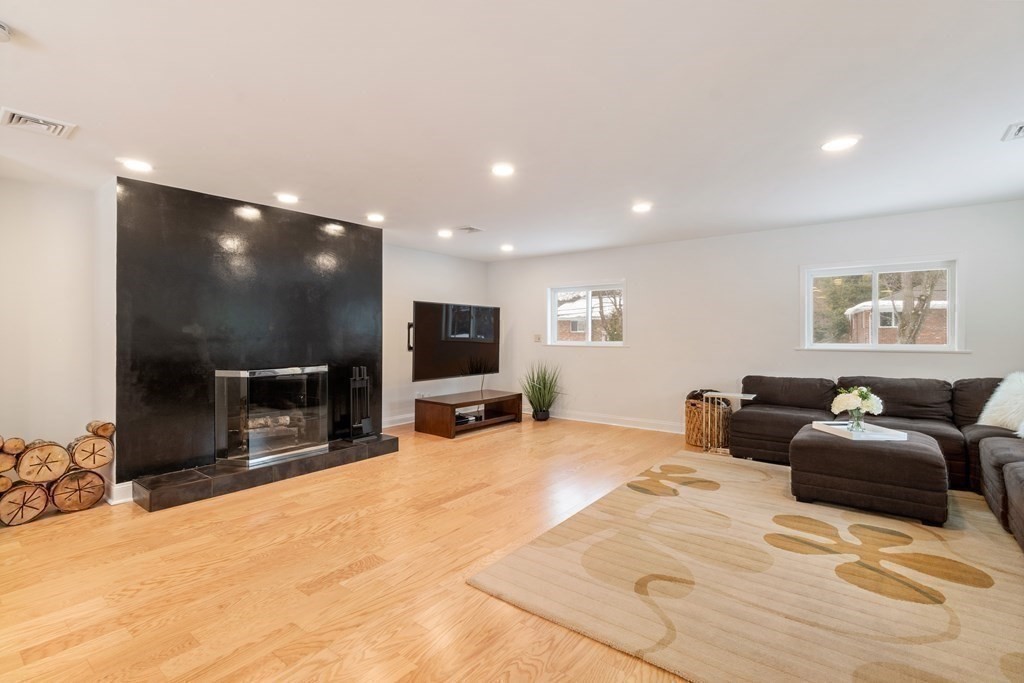 51 Donna Road Newton, MA 02459 - Photo 19 of 30 a large bedroom with a bed a television and a large window