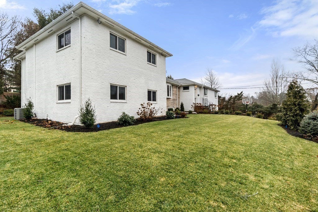 51 Donna Road Newton, MA 02459 - Photo 30 of 30 a white house sitting in the middle of a yard