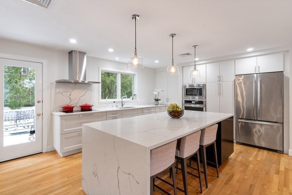 51 Donna Road Newton, MA 02459 - Photo 3 of 30 a kitchen with kitchen island a stove a table and chairs