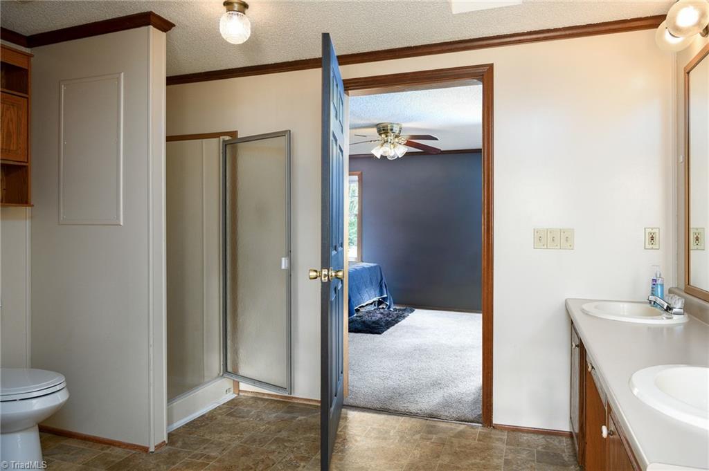 2103 Millcroft Road Pleasant Garden, NC 27313 - Photo 15 of 27 features tub, separate shower, dual vanity and walk in closet