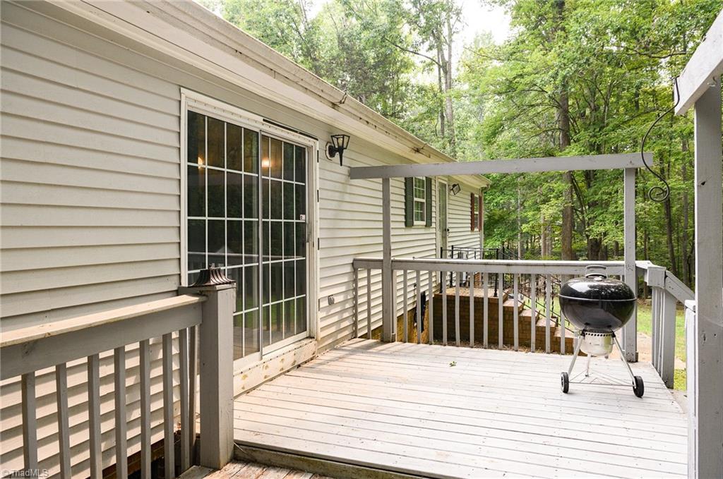 2103 Millcroft Road Pleasant Garden, NC 27313 - Photo 23 of 27 Door from living room leads onto back deck to make entertaining indoors and outdoors a breeze