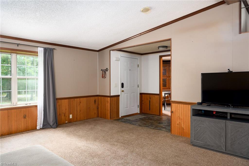2103 Millcroft Road Pleasant Garden, NC 27313 - Photo 5 of 27 Spacious living room is 400+ square feet with vaulted ceiling