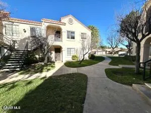 a front view of a house with garden and yard