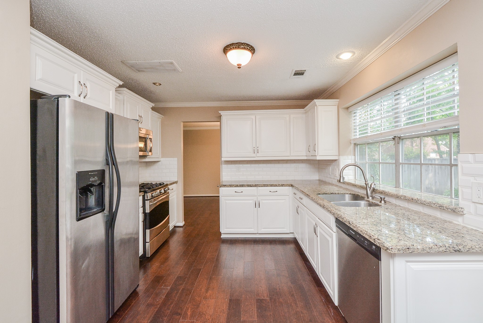 10 Ridgecross Place Spring, TX 77381 - Photo 11 of 32 a kitchen with a sink stove and refrigerator