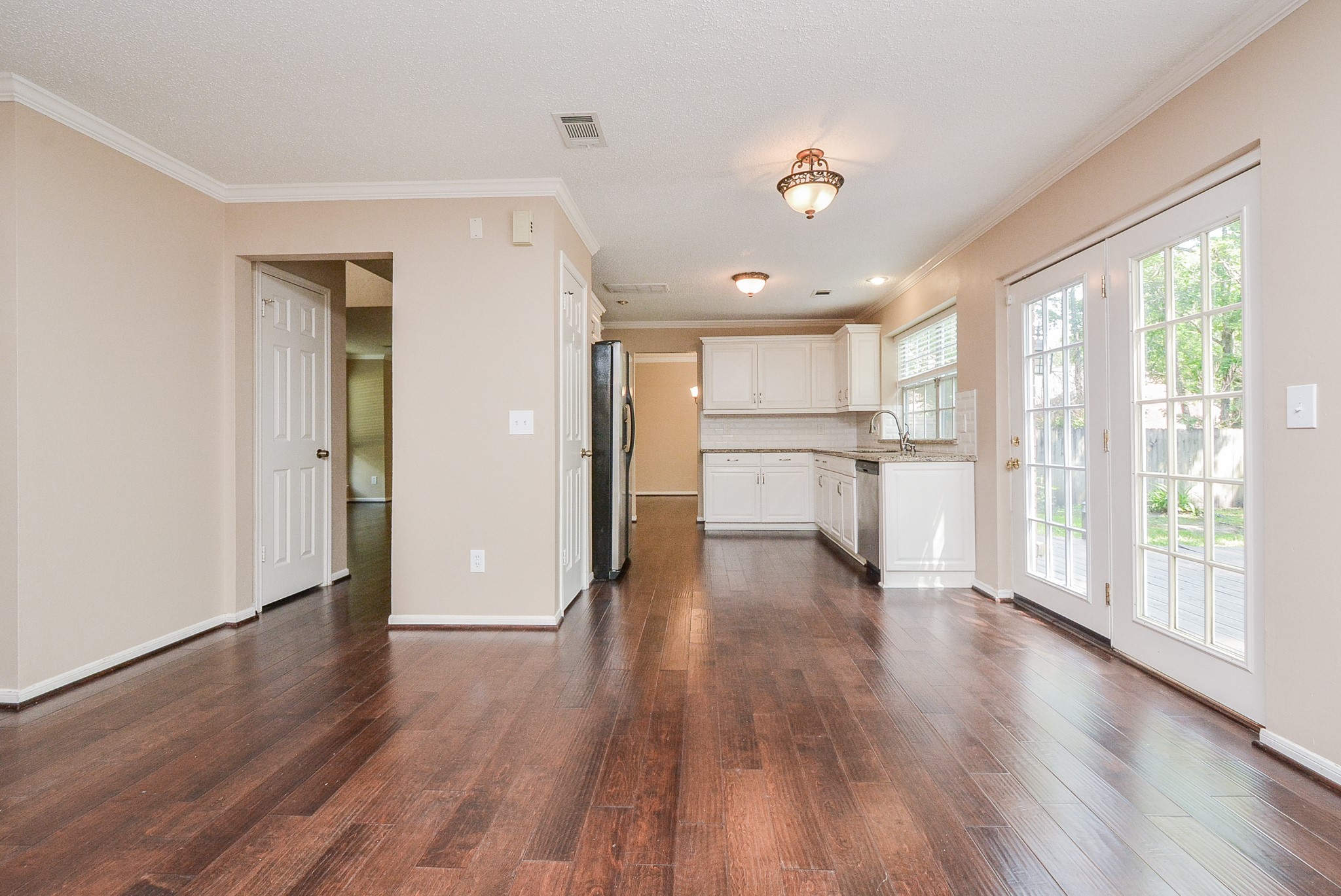 10 Ridgecross Place Spring, TX 77381 - Photo 12 of 32 a view of a kitchen with wooden floor and a refrigerator