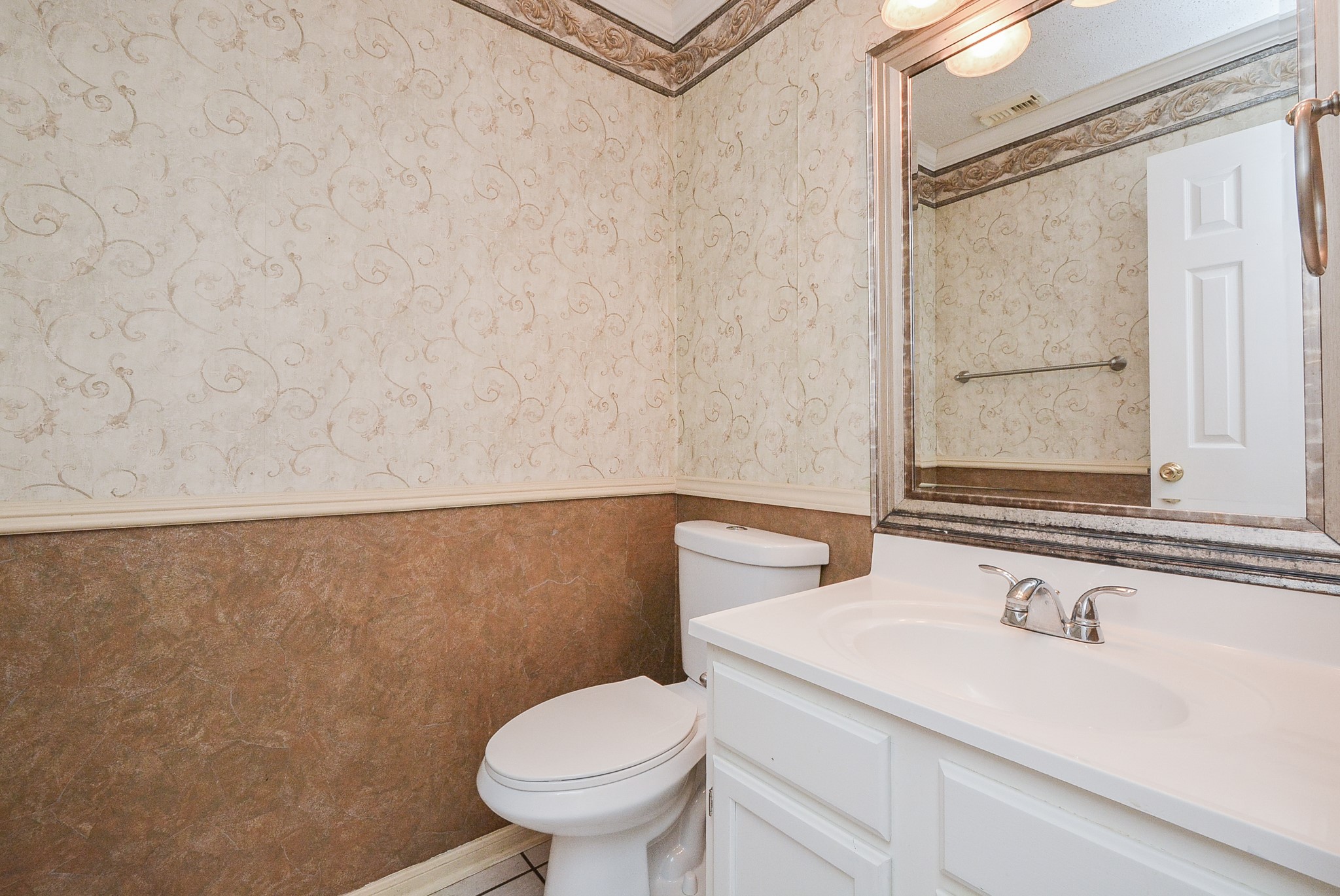 10 Ridgecross Place Spring, TX 77381 - Photo 13 of 32 a bathroom with a sink a toilet and mirror