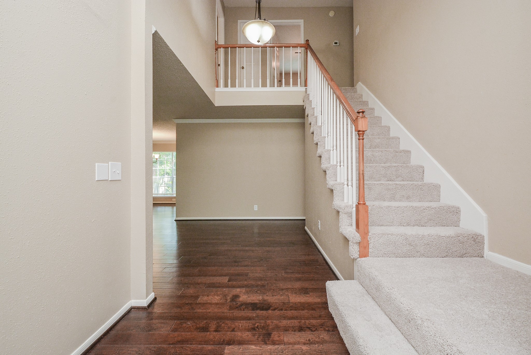 10 Ridgecross Place Spring, TX 77381 - Photo 14 of 32 a view of entryway and hall with wooden floor