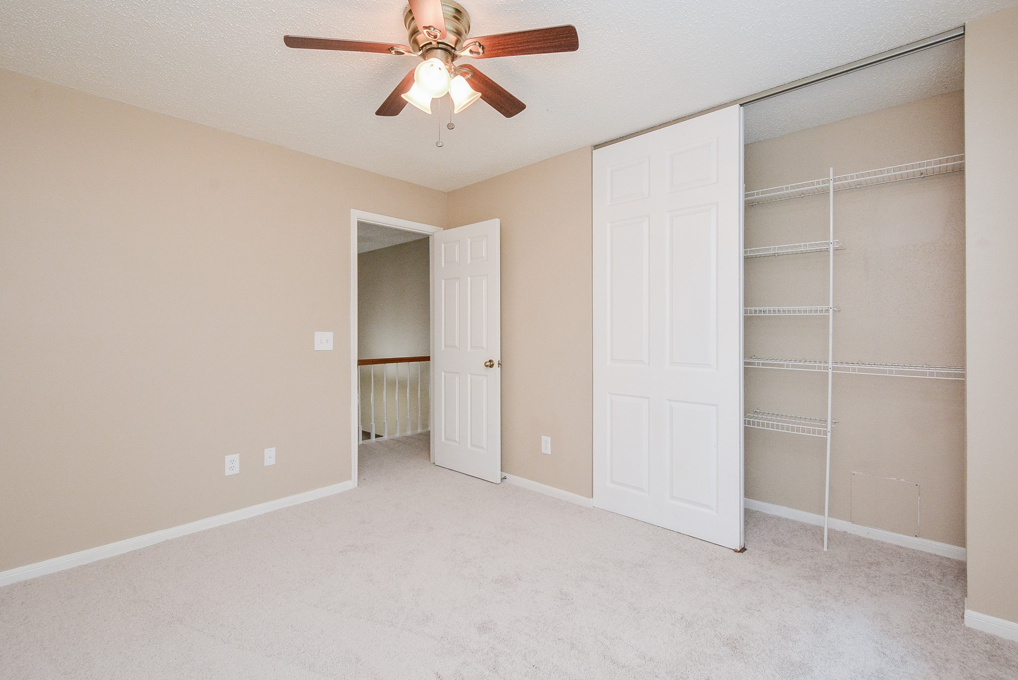 10 Ridgecross Place Spring, TX 77381 - Photo 23 of 32 an empty room with closet and a chandelier fan