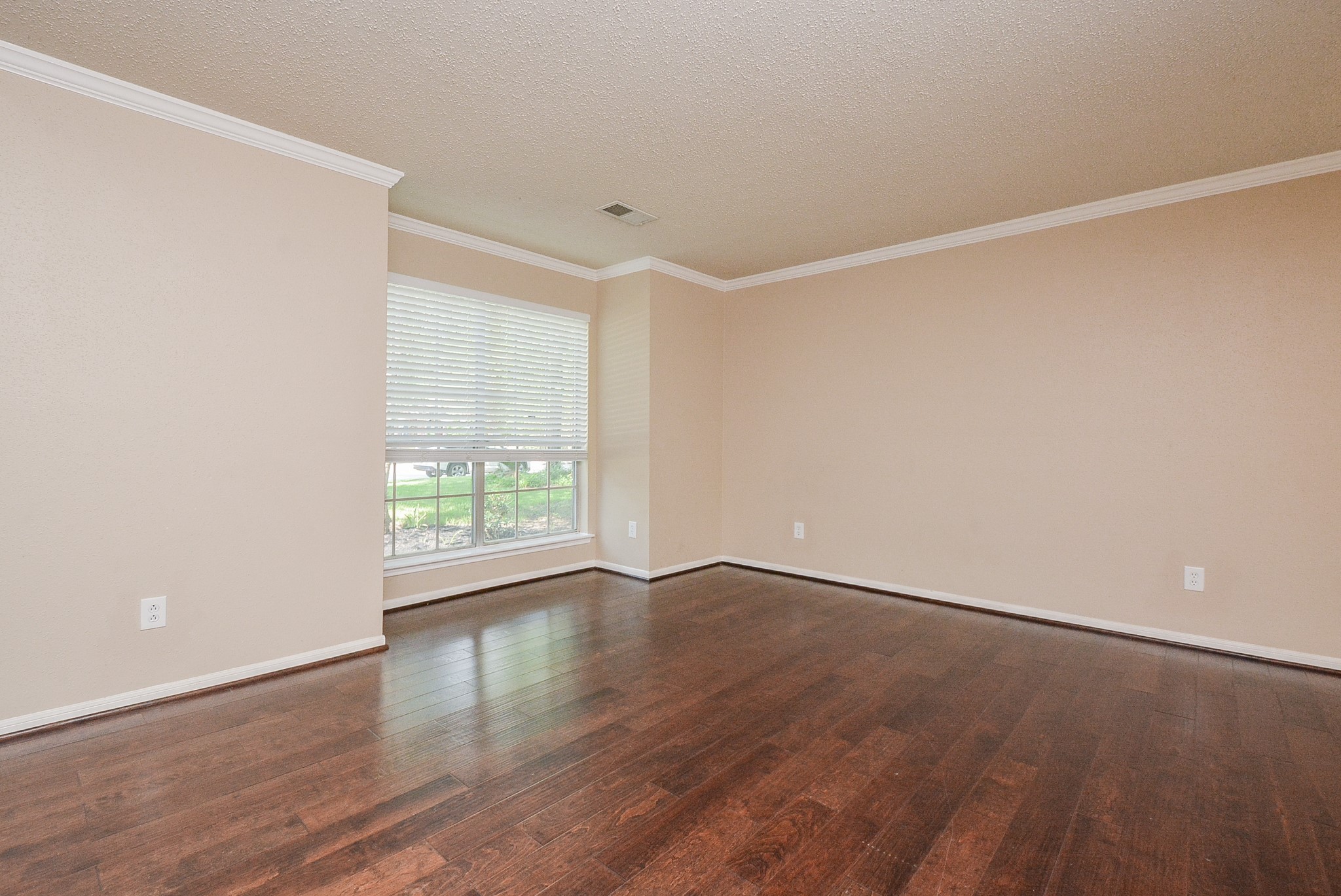 10 Ridgecross Place Spring, TX 77381 - Photo 5 of 32 a view of an empty room with wooden floor and a window