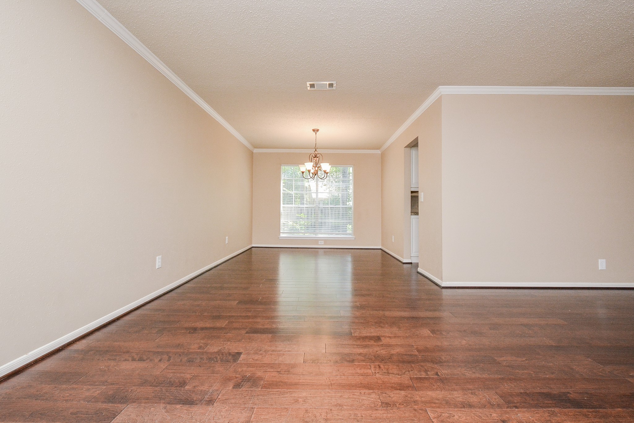 10 Ridgecross Place Spring, TX 77381 - Photo 6 of 32 an empty room with wooden floor and windows