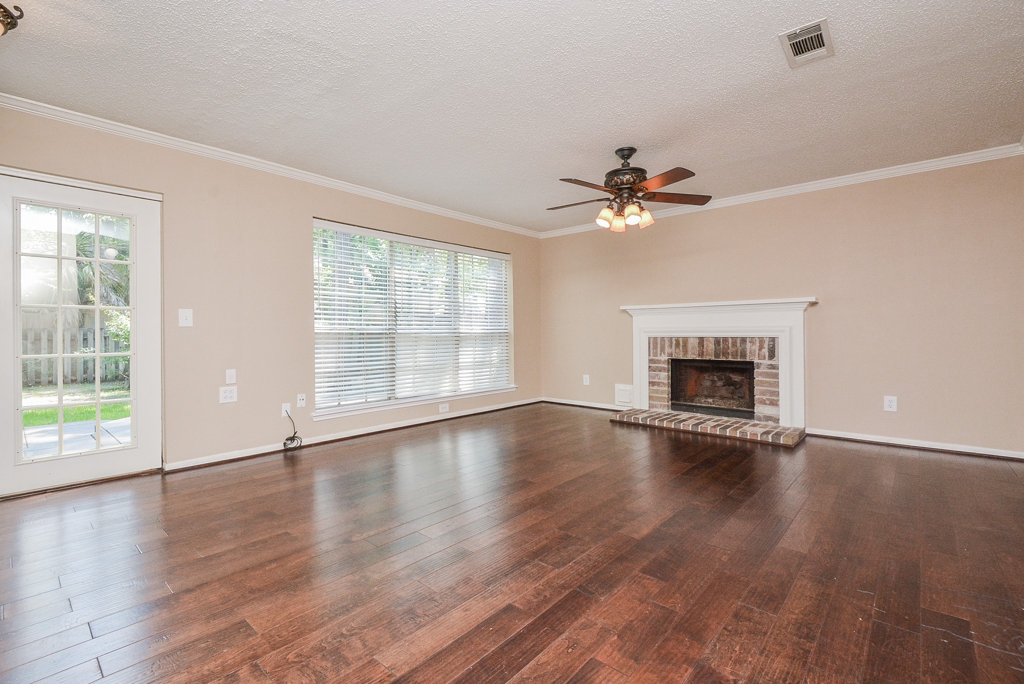 10 Ridgecross Place Spring, TX 77381 - Photo 7 of 32 a view of an empty room with wooden floor and a window