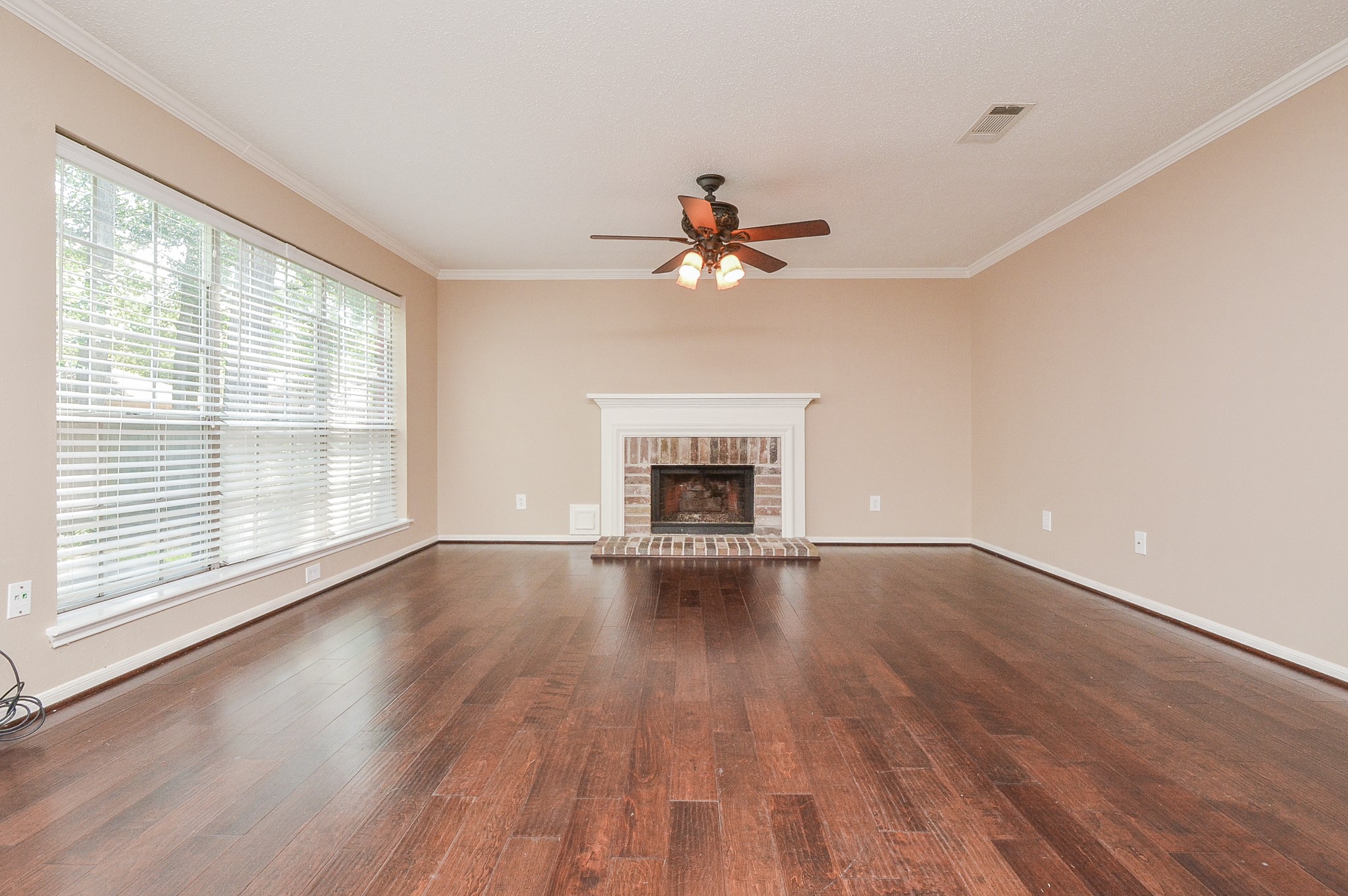 10 Ridgecross Place Spring, TX 77381 - Photo 8 of 32 a view of an empty room with a window and wooden floor