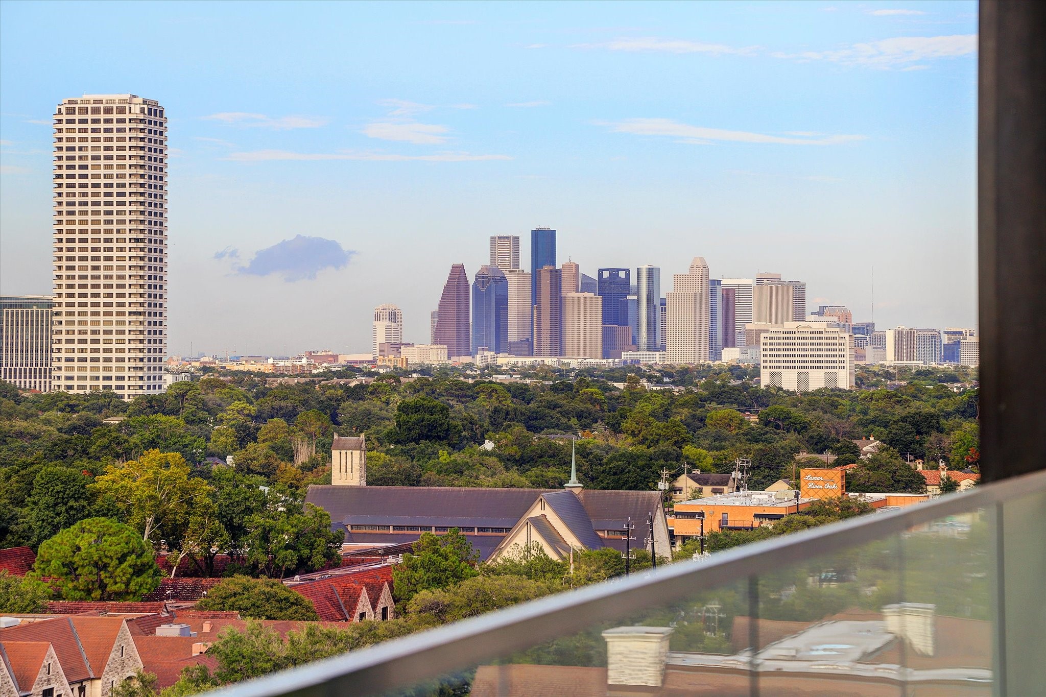 3433 Westheimer Road, Unit 702 Houston, TX 77027 - Photo 47 of 48 Enjoy captivating views of the Houston skyline rising beyond the treetops of River Oaks from your private balcony.