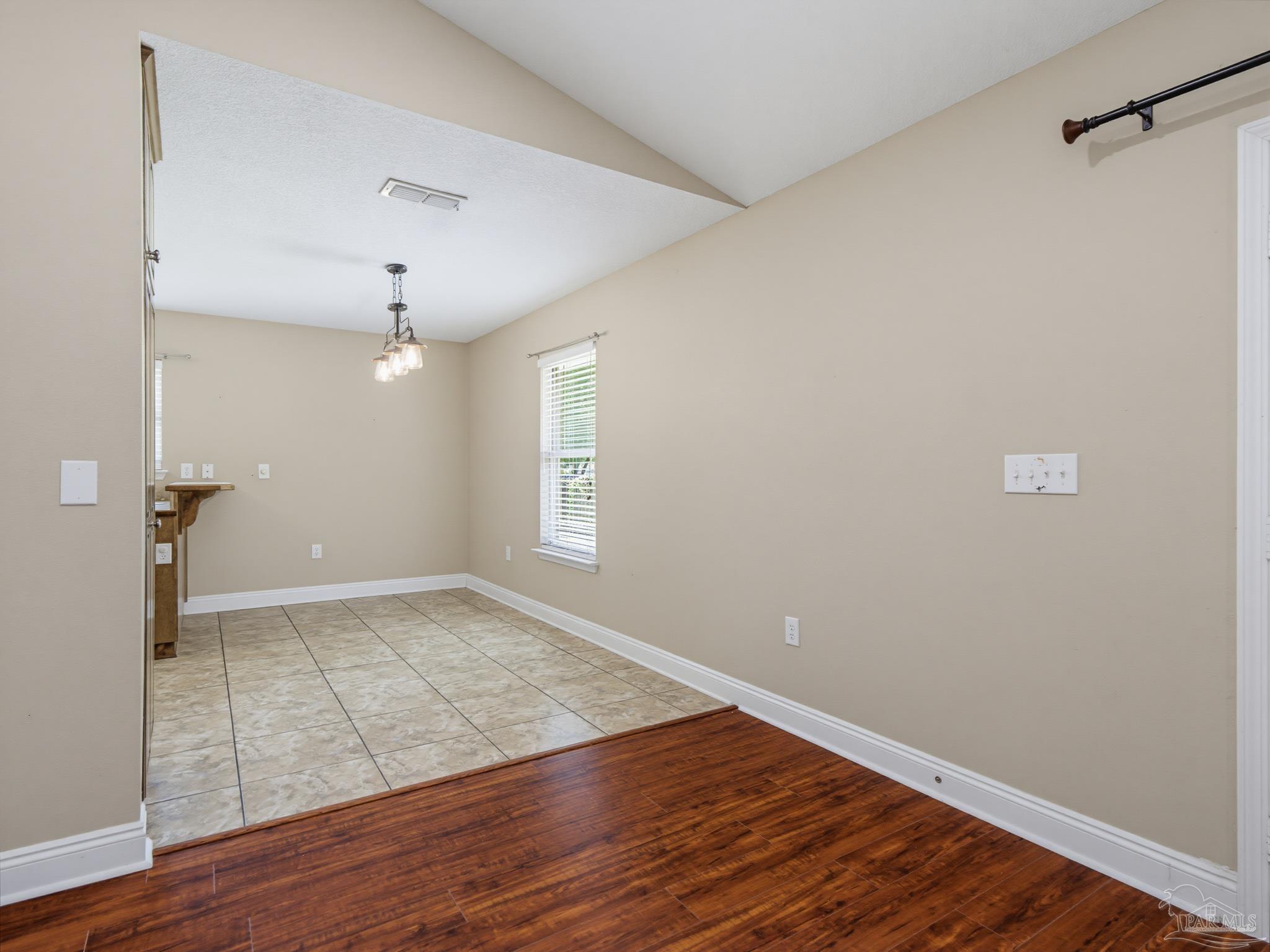 5567 Jones Street Milton, FL 32570 - Photo 11 of 48 wooden floor in an empty room with a window