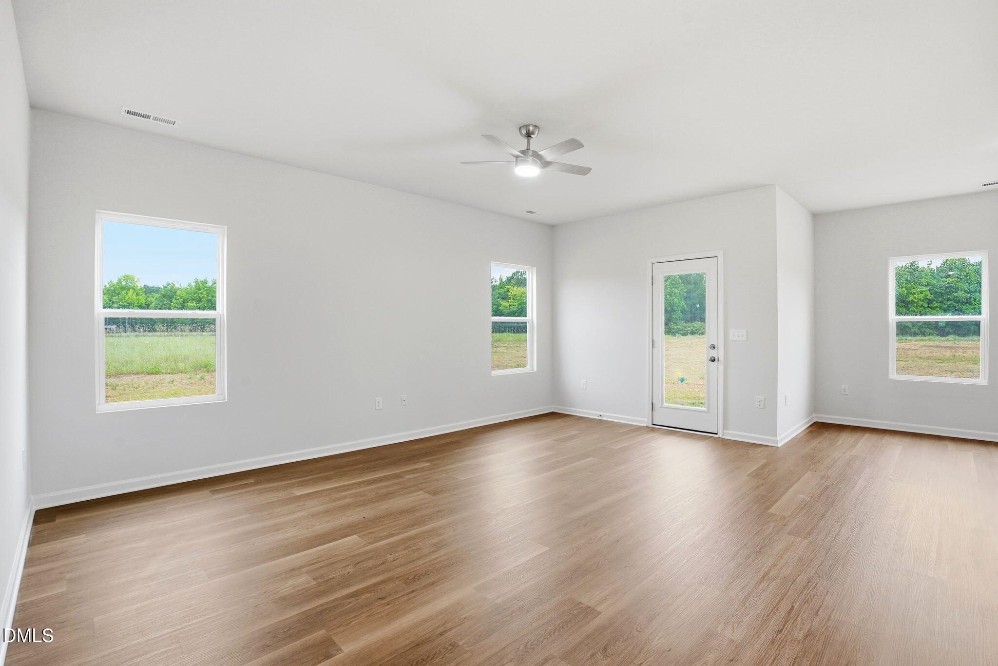 9019 Phoenix Court Spring Hope, NC 27882 - Photo 15 of 34 an empty room with wooden floor and windows