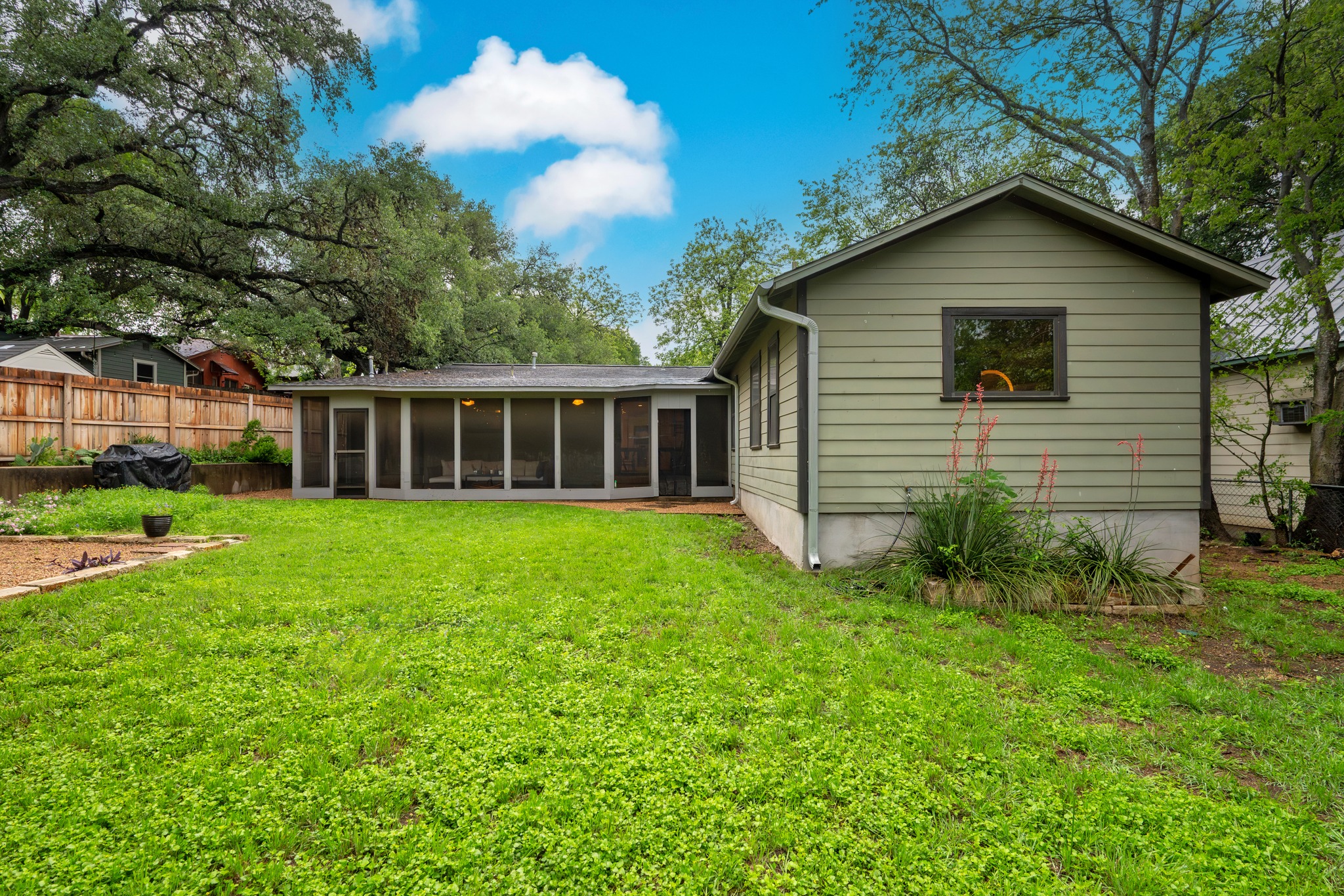 2111 Wright Street Austin, TX 78704 - Photo 29 of 30 a yellow house with a small yard and wooden fence