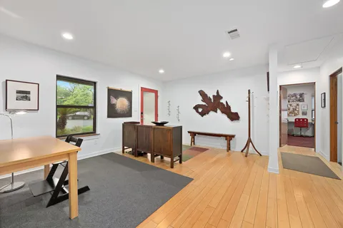 a living room with stainless steel appliances furniture stove and a kitchen view