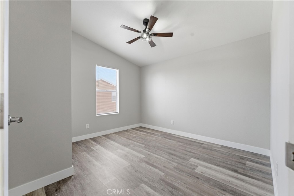 20843 Waalew Road, Unit C125 Apple Valley, CA 92307 - Photo 16 of 38 wooden floor in an empty room with a window