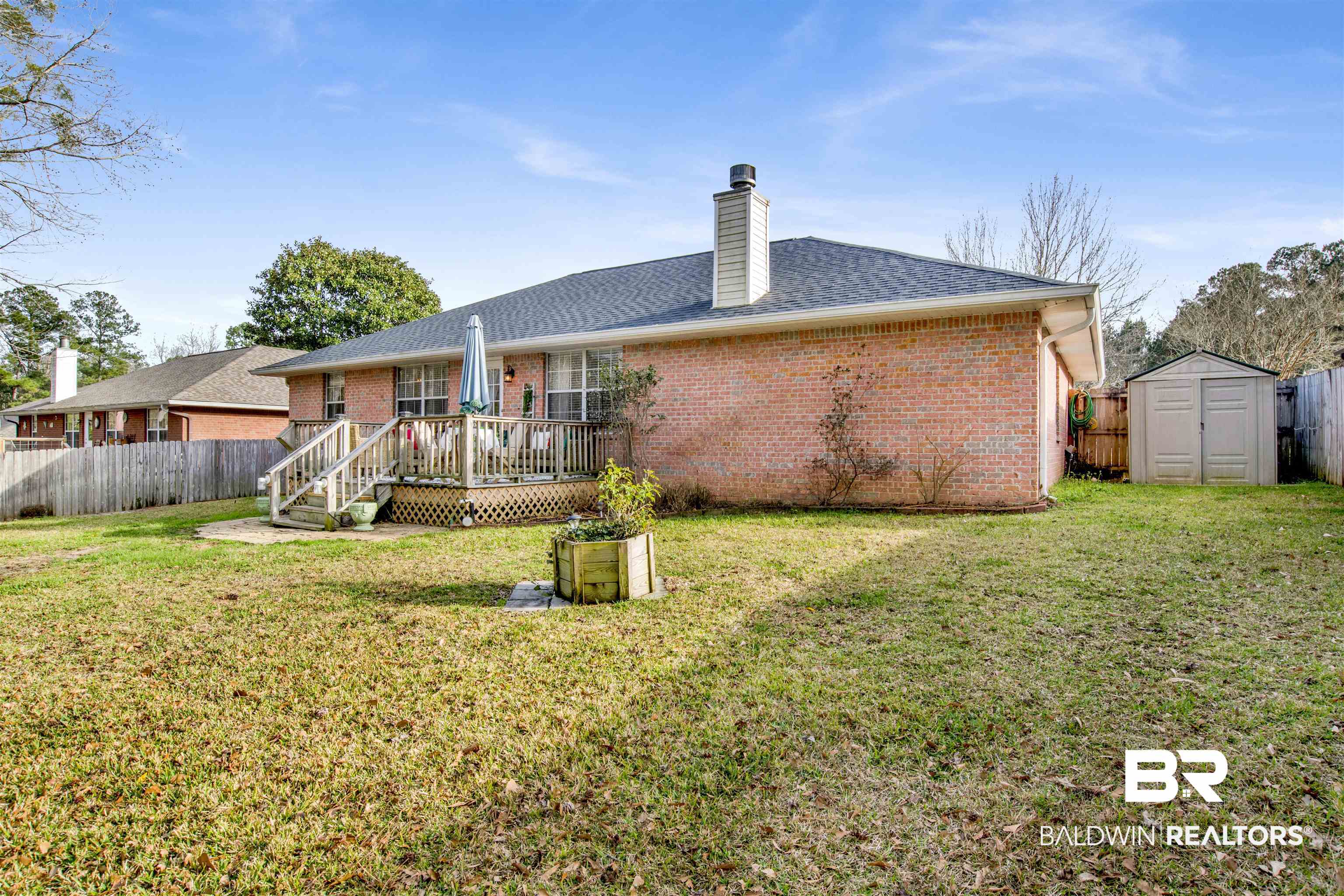 11697 Balsam Court Daphne, AL 36527 - Photo 29 of 31 Back of house featuring a yard, a deck, and a storage unit
