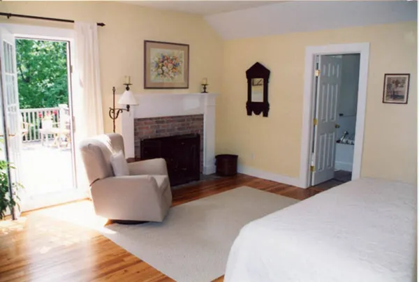 a bedroom with furniture and a fireplace