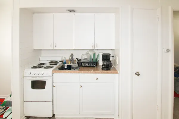 a kitchen with appliances cabinets and utility