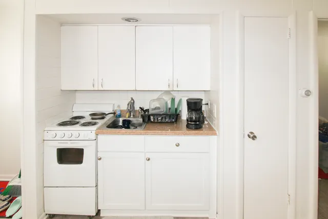 a kitchen with appliances cabinets and utility
