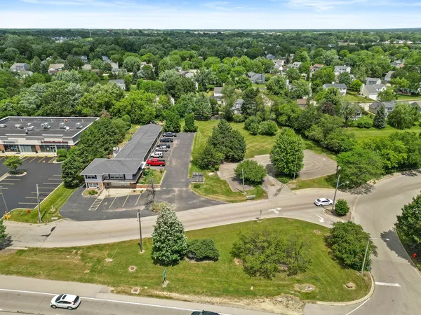 an aerial view of a house with a yard