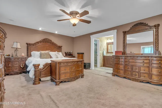 a spacious bedroom with a bed and a chandelier