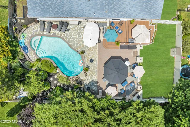 an aerial view of a house with a swimming pool