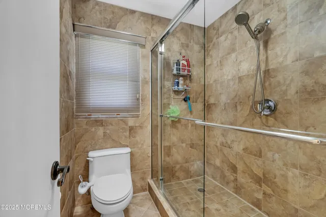 a bathroom with a toilet and shower
