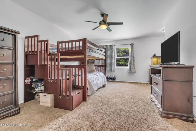 a bedroom with furniture and a flat screen tv