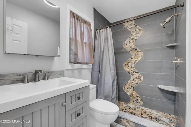 a bathroom with a sink toilet and shower