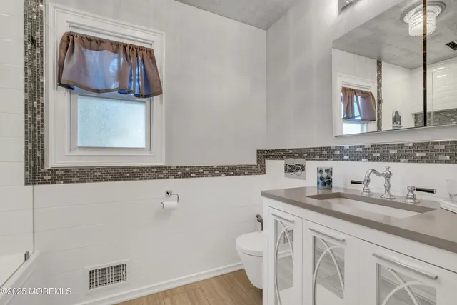 a bathroom with a sink a vanity and a mirror