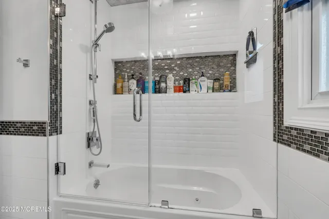 a bathroom with a bathtub and a shower