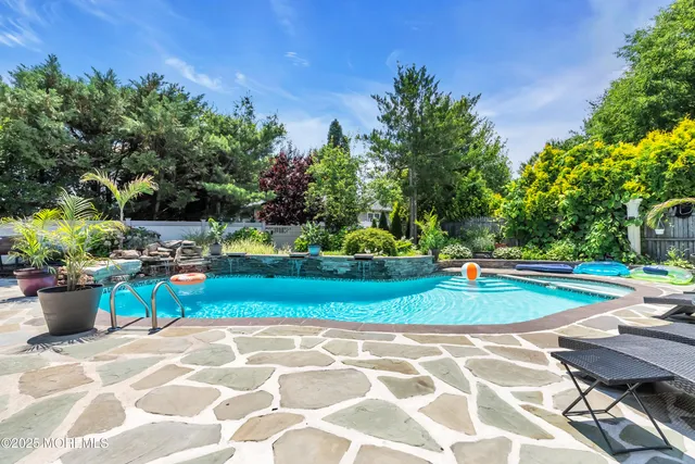 a view of a backyard with sitting area