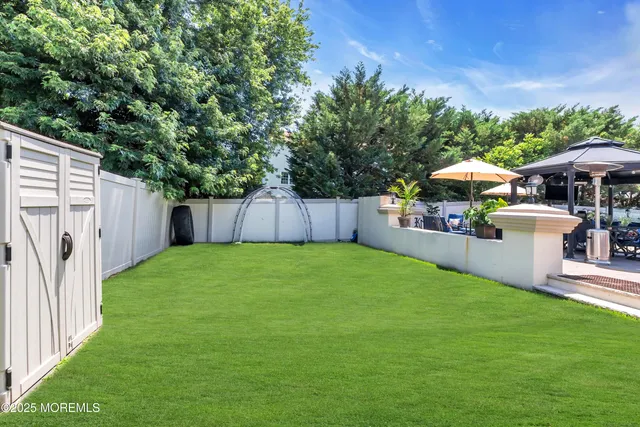 a view of a backyard with a patio and fire pit