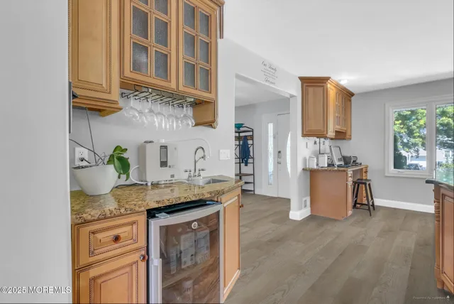 a kitchen with stainless steel appliances granite countertop a sink stove and cabinets