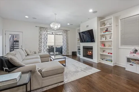 a living room with furniture a fireplace and a chandelier