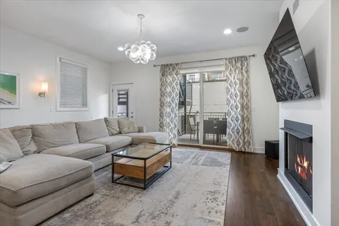 a living room with fireplace furniture and a flat screen tv