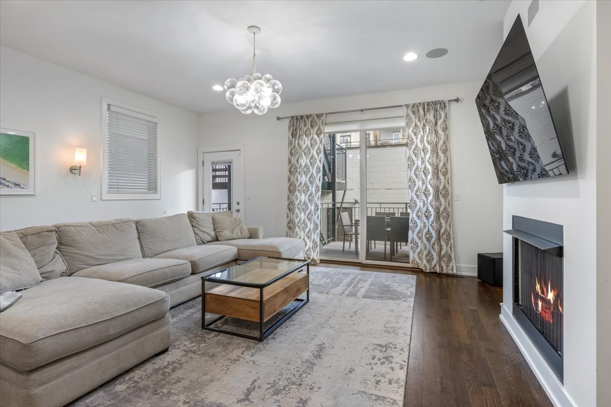 951 North Winchester Avenue, Unit 1 Chicago, IL 60622 - Photo 12 of 28 a living room with furniture a fireplace and a chandelier